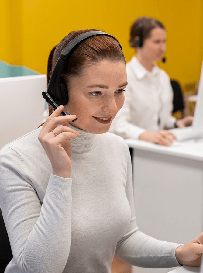 Woman working in a call center talking with clients using headphones and microphone(1)